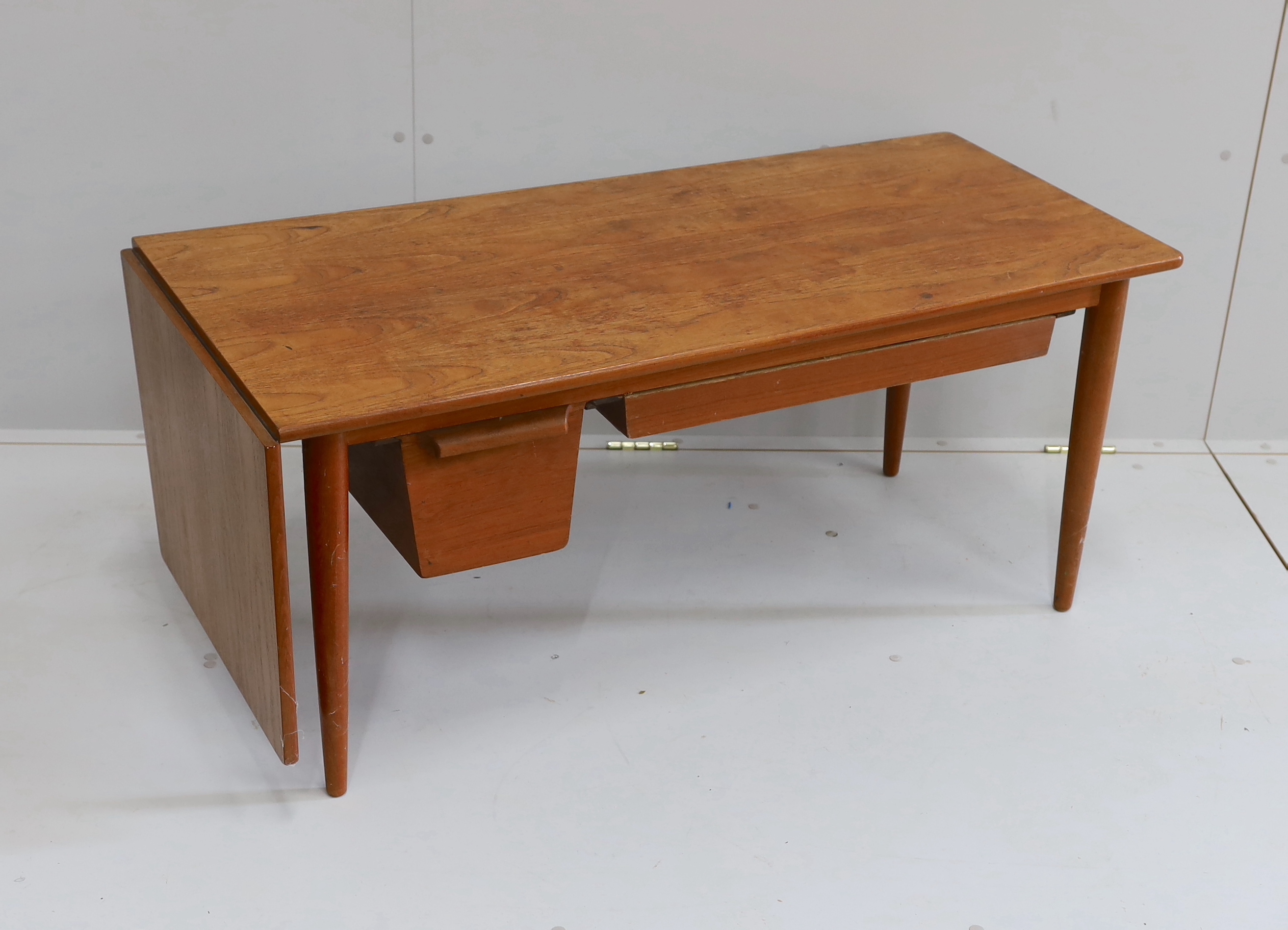 A mid century Danish design rectangular teak drop flap coffee / work table, width 117cm, depth 54cm, height 51cm (drawer runners in need of repair)